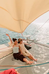 Sunbathing on the trampoline deck under a sail on SY Mawali catamaran near Kota Kinabalu