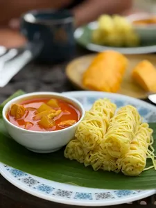 Malaysian comfort food of noodles and curry soup served on a banana leaf at Kebun Lidstari farmhouse kitchen in Langkawi