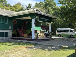 Sukau Greenview Lodge in Sandakan with porch and parked van in the driveway, part of a stay on the Kinabatangan River