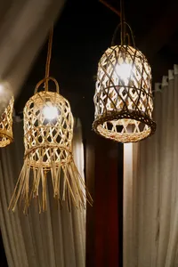 Woven pendant lanterns glowing in a rustic courtyard where a Traditional Manggarai vegan cooking class is hosted, Labuan Bajo