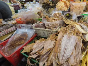 Packaged dried seafood and fish at a busy Singapore hawker market for the Pasar Fish Chinatown Cantonese fish tour