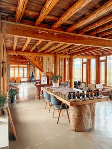 Wooden coffee tasting hall at Seeker Yunnan Coffee Estate in Lijiang, long counter set up with bottles and coffee-brewing gear