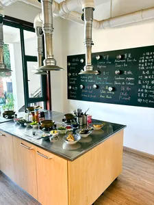 Lijiang cooking station for a Yunnan market-to-table class, with ingredient bowls and recipe notes on a chalkboard