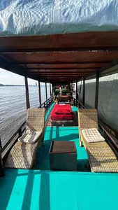 Small boat deck with cushioned loungers and open windows along the water on a 3D2N Sister Tour cruise, Tanjung Puting