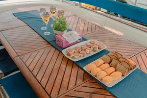 Breakfast spread on the deck of a catamaran sailing off Kota Kinabalu, with pastries, muffins and fresh drinks