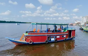 Sister Tour red small boat ready for a 3D2N couple cruise on the waterways in Tanjung Puting National Park, Pangkalan Bun
