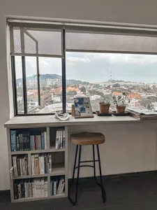 Singapore window-side books and cups with a wide city view, set up for a TCM mocktails and food-as-medicine session