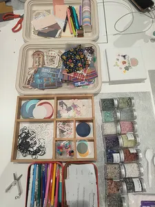Overhead view of Gemstory vision-boarding supplies and finished collages in the studio for workshops in Singapore