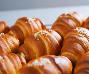 Golden shio pan rolls sprinkled with pearl sugar on a baking tray, prepared for hands-on workshops in Singapore