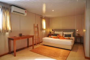 Seaventures Dive Rig cabin bedroom with air-conditioning, a double bed and folded towels for a 4D3N offshore rig stay