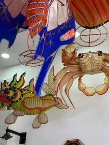 Fish- and animal-shaped paper lanterns hanging from the ceiling in a Ho Chi Minh City craft workshop for lantern-making
