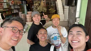 Group selfie in Katong-Joo Chiat, Singapore, during a real-life Monopoly team building game inside a shopfront lane  Singapore hidden gems