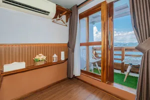 Bright boat-cabin room with open wooden door and sea-view balcony outside, La Famille 3D2N Join-In Komodo trip in Labuan Bajo