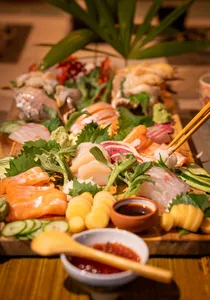 Primateve grazing platter spread of sashimi, vegetables and dipping sauces with chopsticks at a private dining Singapore experience