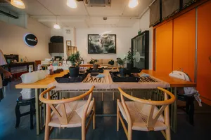 Japanese-style tropical bonsai workshop room in Singapore with empty chairs, worktables, tools and potted trees for arranging