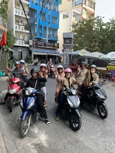 Motorbike group posing for a guide on a busy street in Ho Chi Minh City during the Saigon hidden craft alleys tour