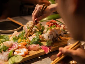 Primateve host serving a grazing platter with chopsticks on a private dining Singapore table in Singapore