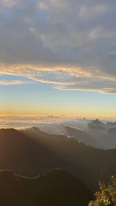 Golden-hour sunrise over layered cloud valleys from the Sapa mountains during a 1-day eco trek, at Mt Fansipan