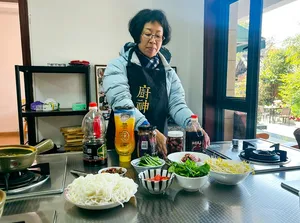 Fancy preparing a Yunnan meal in a bright Lijiang kitchen, arranging noodles and vegetables beside bottles and utensils