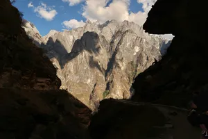 Dramatic cliffs and snow-capped peaks overlooking Tiger Leaping Gorge on a 2D1N high-trail hike from Lijiang