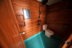Travass Life 3D2N join-in Komodo trip cabin bathroom with toilet, hand shower and wooden walls, Labuan Bajo