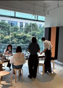 Pottery class in a bright Singapore studio as participants work at tables by large windows for workshops in Singapore
