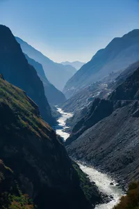 Winding river through deep mountain valleys in Shangri-La, viewed from a hiking trail overlook at blue hour