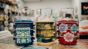 Painted Peranakan tingkat containers in the studio during workshops in Singapore on traditional techniques
