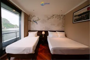 Sunshine Golden Cruises twin cabin on a Cat Ba cruise with two beds and floor-to-ceiling window overlooking the bay