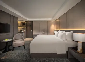 Doris Cruise cabin with king-size bed, sofa chair and bedside lighting on a 2D1N Lan Ha Bay cruise in Vietnam