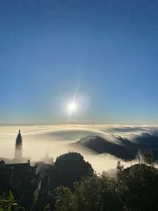 Sunrise with sun flare over a sea of clouds and mountain ridges from Sapaâs Fansipan region, Mt Fansipan