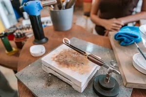 Silver ring-making tools and metal blanks on a bench at Fat Anvil Studios in Singapore, workshops in Singapore