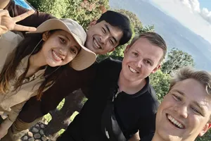 Small group of travellers smiling on a scenic stop during a day trek with Wildlife Safari Thailand in Khao Yai National Park