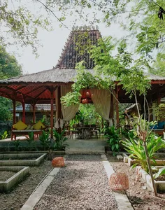 Garden courtyard seating with draped curtains at The Kitchen Garden Bajo for Traditional Manggarai vegan cooking, Labuan Bajo