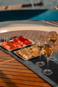 Seafood and watermelon appetisers with champagne glasses served on the wooden deck of a catamaran cruise off Kota Kinabalu