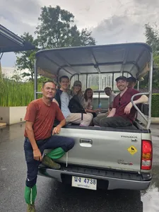Travellers riding in the back of a pickup truck on a guided wildlife trek in Khao Yai National Park, Thailand