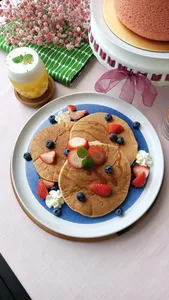 TCM-inspired teatime pancakes with berries on a blue platter at a Singapore workshop, hands-on workshops in Singapore