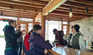 Guests cupping Yunnan specialty coffee at a family-run workshop in Lijiang, tasting from small cups and discussing flavours