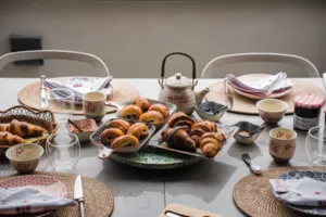 Croissants on serving trays with teapot and cups on a dining table in Singapore for a French Cooking Lab class, workshops in Singapore