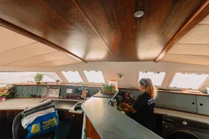 Inside SY Mawali, Mawali Sailing crew at the helm as the catamaran cruises out of Kota Kinabalu