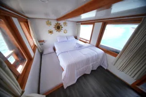 Two twin beds inside an onboard cabin on a join-in 3D2N Komodo trip, with sea views near Komodo Island