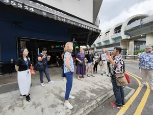 Small group listening near a shophouse on Indie Singapore Tours’ private night walk through Geylang, Singapore hidden gems