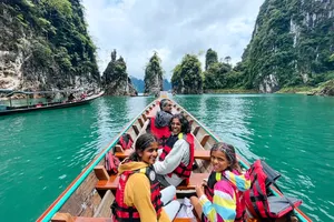 A group on a boat along limestone cliffs on Cheow Lan Lake during the 3D2N stay with Khao Sok Riverside Cottages