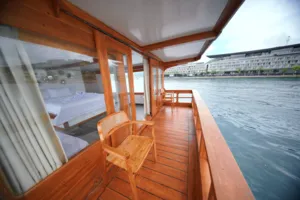 Wooden boat deck with a chair set, cruising in calm waters during a 3D2N join-in Komodo trip from Labuan Bajo to Komodo Island