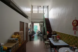 Jalan Besar backroom corridor with tiled floor, stairs, and stored clutter in Singapore, revealing Singapore hidden gems