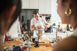 French Cooking Lab chef pouring ingredients into a stand mixer on the counter in Singapore for workshops in Singapore