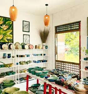 Ilham Ceramic Studio in Langkawi village with shelves of handmade bowls, cups and plates under hanging lamps