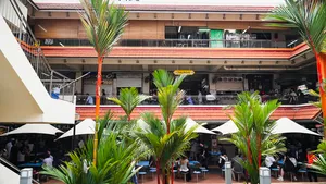 Courtyard hawker centre in Singapore with shared dining tables and open-air seating, part of Jenny Dorsey’s stories — Singapore hidden gems