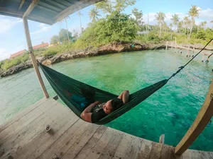 Hammock on the deck of a sea lodge overlooking calm tropical water in Semporna, relaxing during the Luma Selakan 2D1N stay