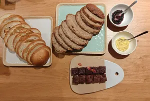 Tasting table with sliced shio-pan-style bread, butter and jam, plus brownies on wooden boards at The Daily Staples workshops in Singapore